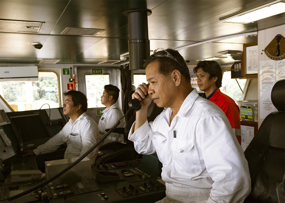 Filipino ship captain and officers on the deck of a commercial vessel